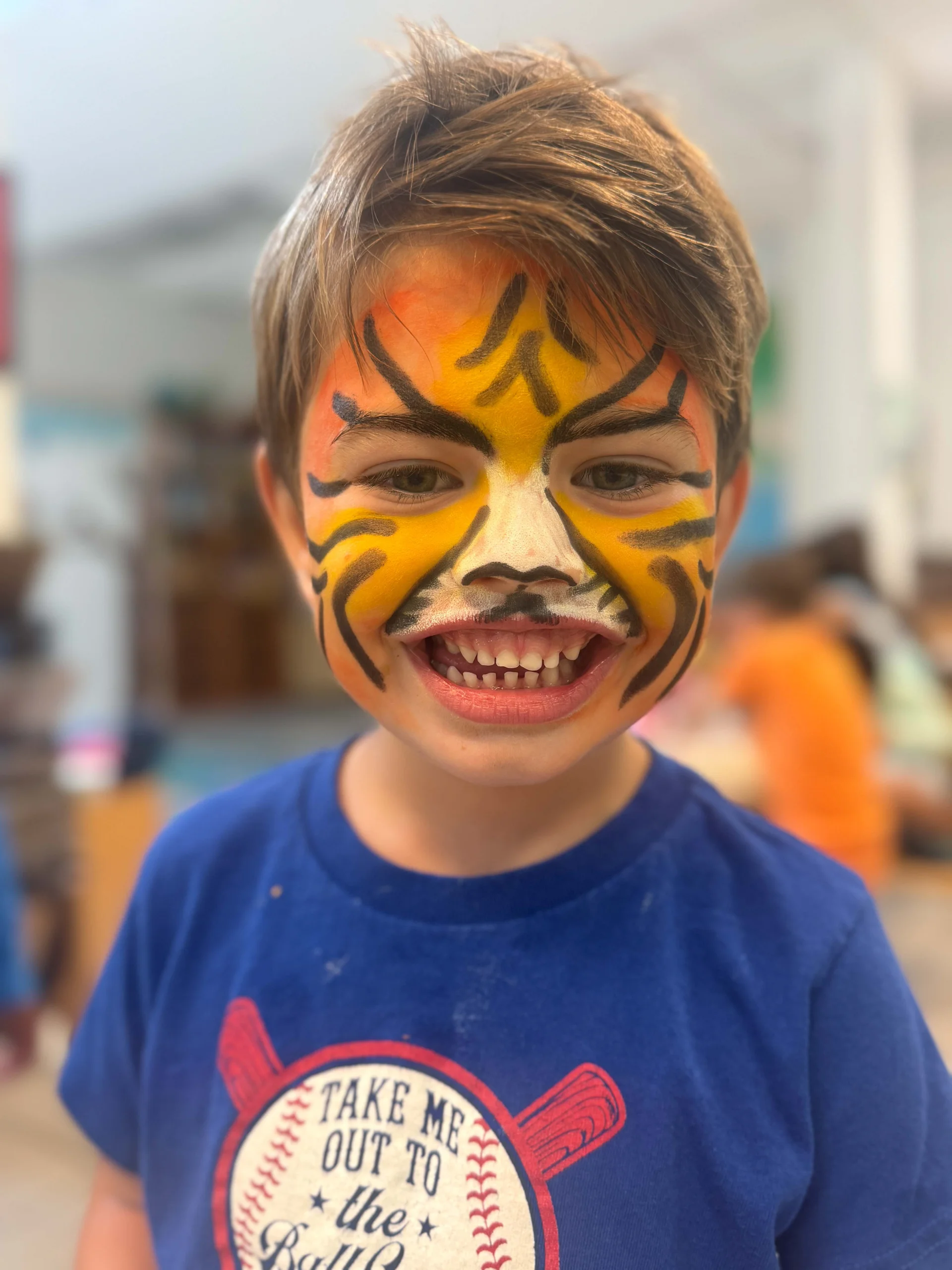 camper with face painted at his summer camp